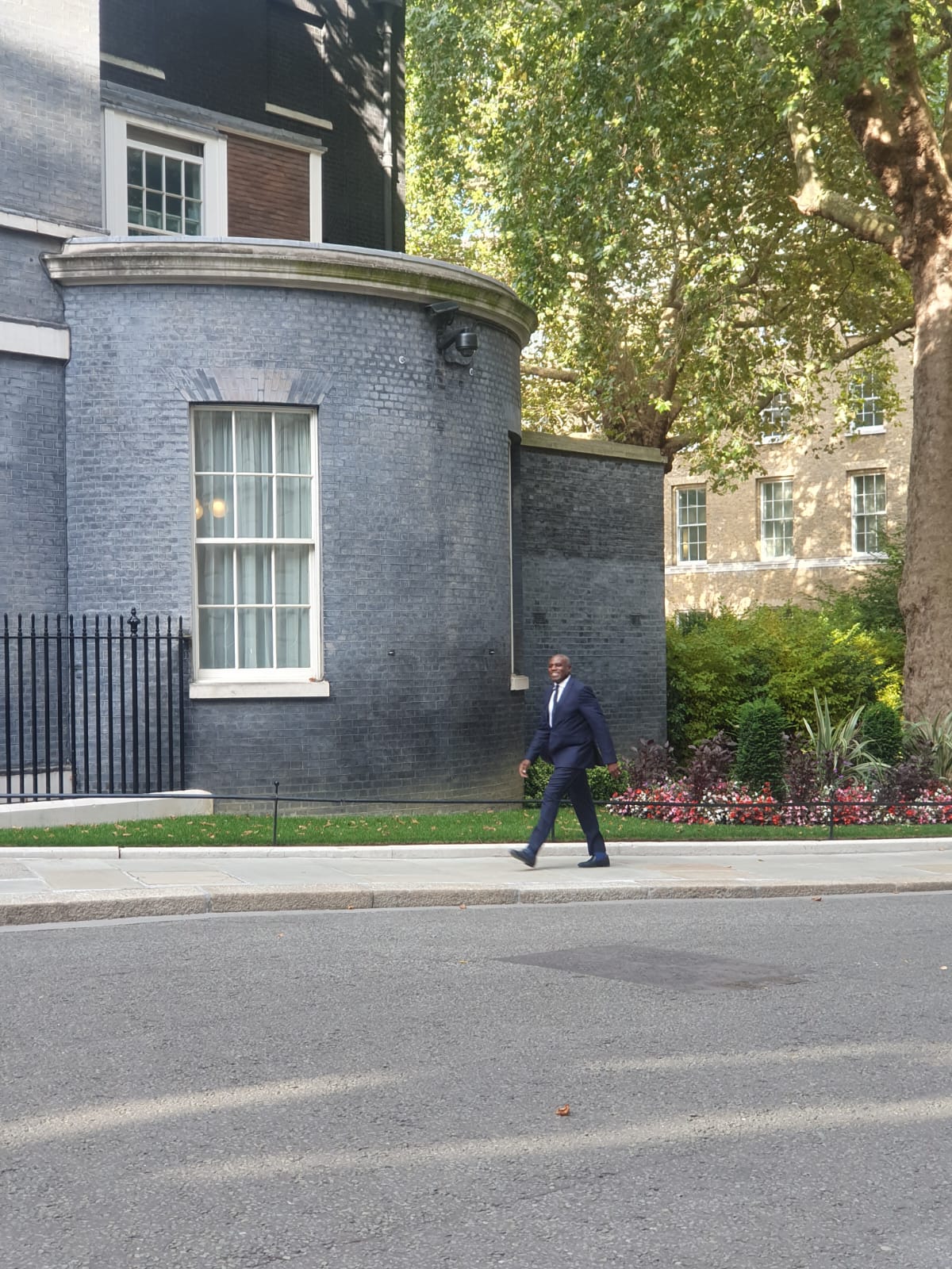 David Lammy smiling while walking towards 10 Downing Street